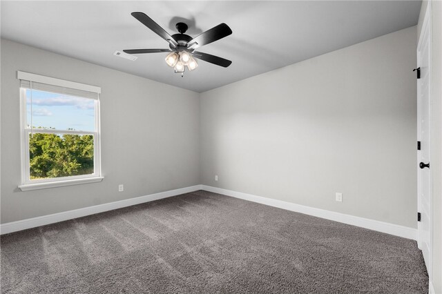 empty room featuring ceiling fan and carpet floors