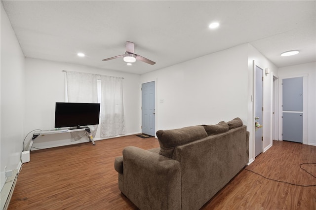 living room featuring baseboards, a ceiling fan, wood finished floors, and recessed lighting