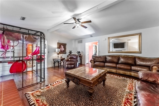 living room featuring wood-type flooring, ceiling fan, and vaulted ceiling with beams