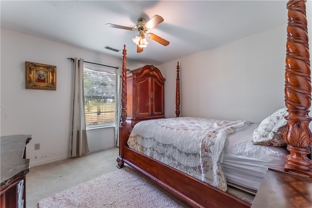 bedroom with ceiling fan and light colored carpet