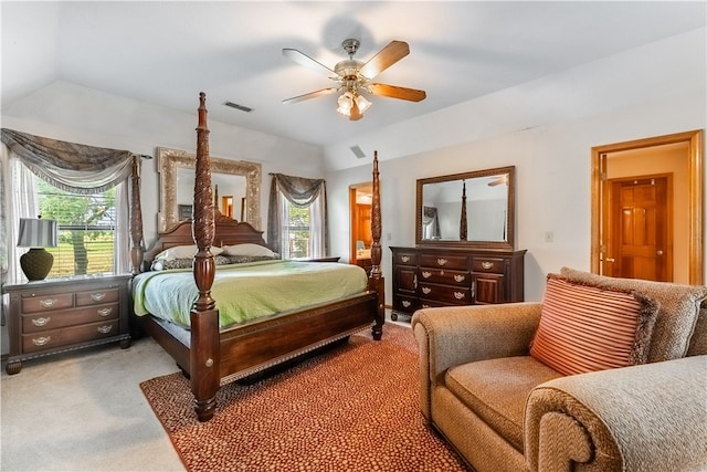 carpeted bedroom featuring multiple windows, ceiling fan, and vaulted ceiling