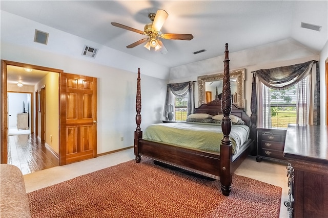 bedroom with lofted ceiling, light colored carpet, and ceiling fan