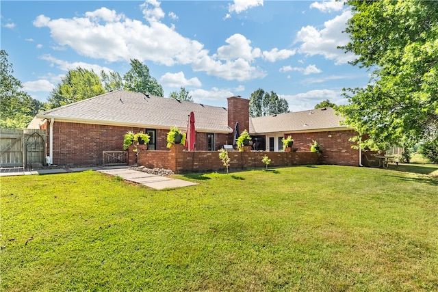 rear view of house with a yard