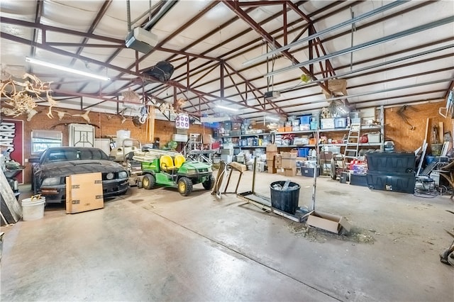 garage with a workshop area and a garage door opener