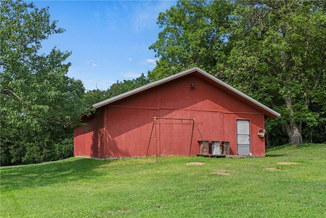 view of outbuilding with a lawn