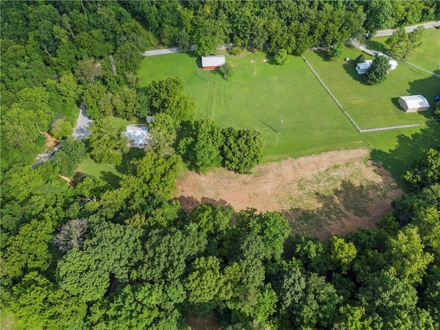 birds eye view of property with a view of trees and a rural view