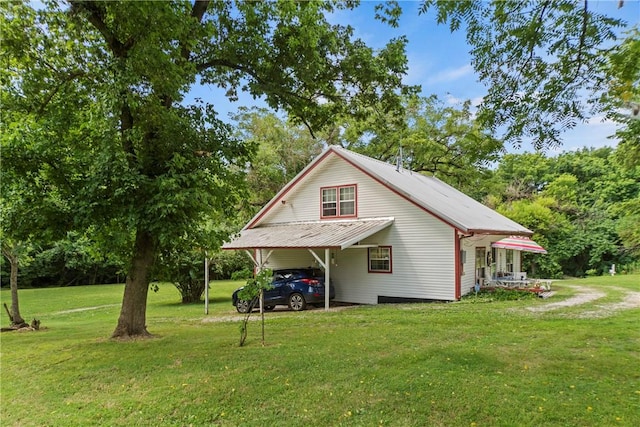 view of home's exterior featuring a carport and a yard