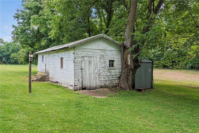 view of outbuilding with a lawn