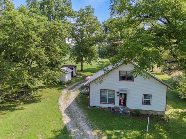 view of front of property with a front yard and an outdoor structure