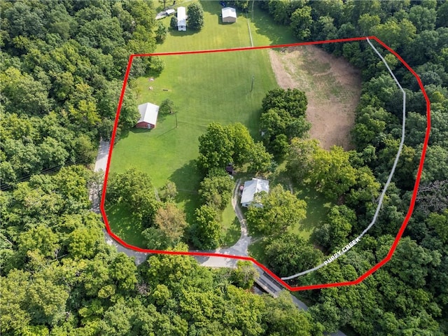 birds eye view of property featuring a wooded view