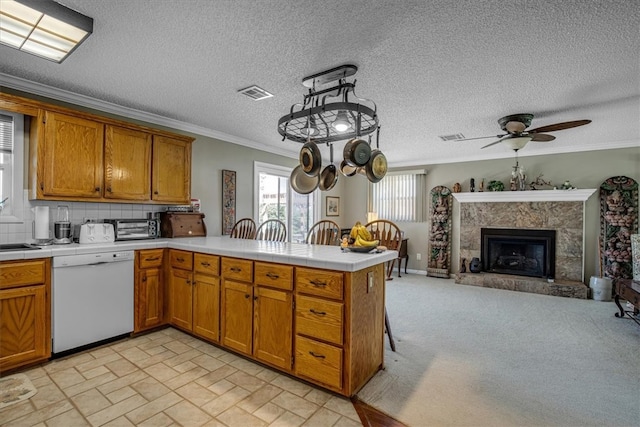 kitchen featuring tasteful backsplash, light tile patterned floors, kitchen peninsula, dishwasher, and ceiling fan