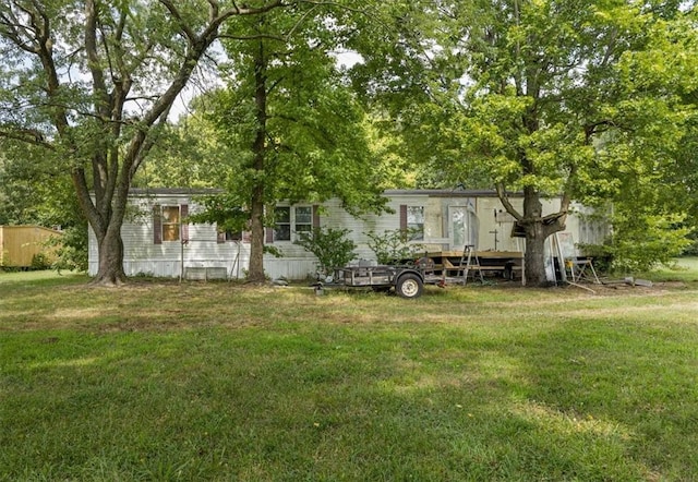 rear view of house featuring a lawn