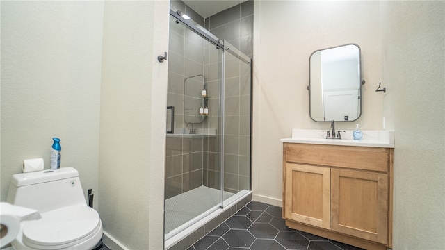 bathroom featuring tile patterned flooring, toilet, vanity, and an enclosed shower