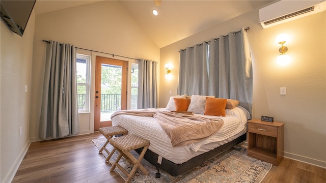 bedroom with access to exterior, a wall unit AC, wood-type flooring, and high vaulted ceiling