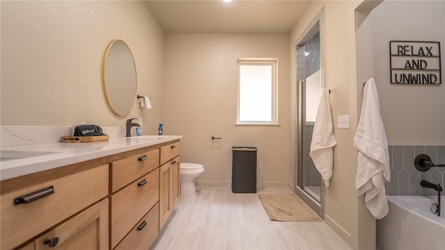 full bathroom with dual vanity, shower with separate bathtub, tile patterned flooring, and toilet