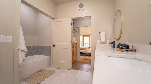 bathroom featuring hardwood / wood-style flooring and a washtub