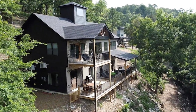 back of house featuring a balcony