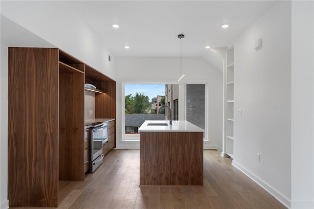 kitchen featuring open shelves, light wood-style floors, a sink, and stainless steel range with electric cooktop