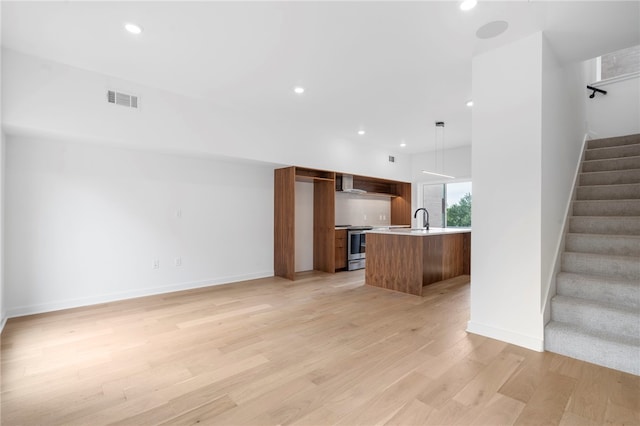 interior space with recessed lighting, visible vents, baseboards, stairway, and light wood finished floors