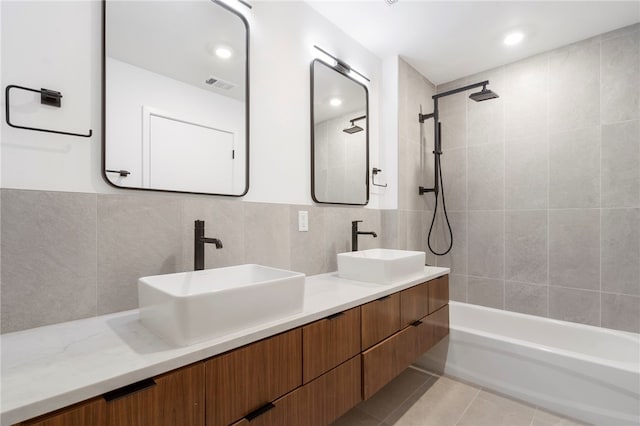 bathroom featuring double vanity, tile patterned flooring, a sink, and visible vents