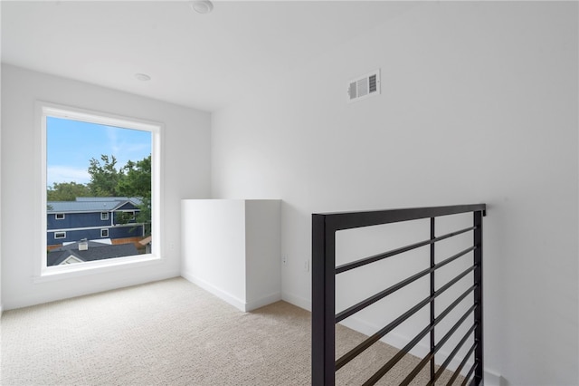 bonus room featuring carpet flooring, visible vents, and baseboards