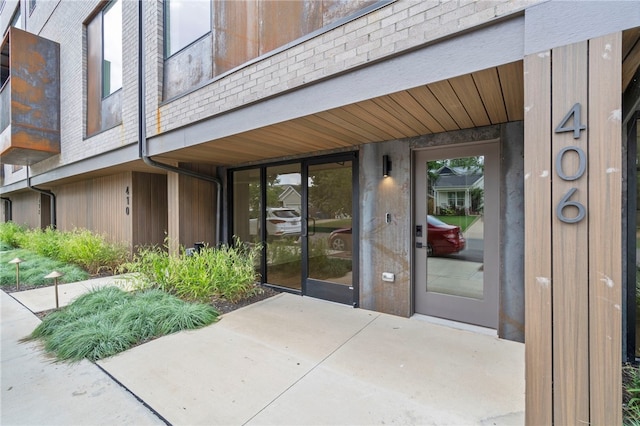 property entrance featuring brick siding