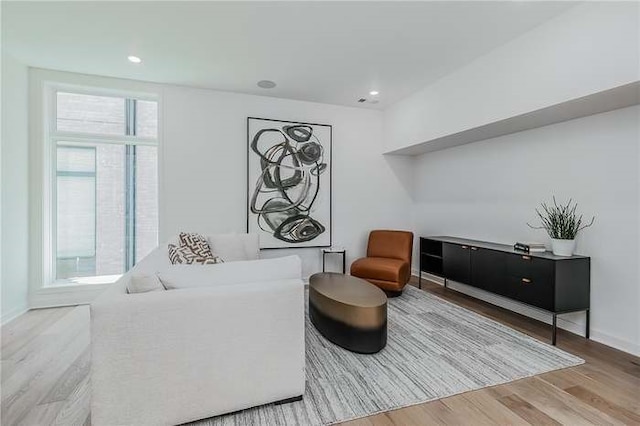 sitting room with recessed lighting, baseboards, and wood finished floors