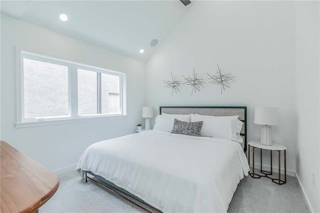 carpeted bedroom with vaulted ceiling, recessed lighting, and baseboards