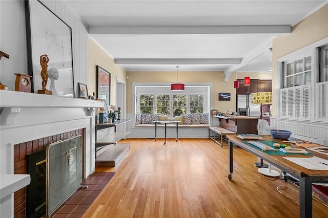 dining area featuring dark hardwood / wood-style flooring, ornamental molding, and beam ceiling