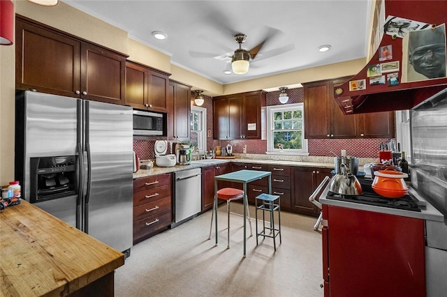 kitchen with sink, ceiling fan, stainless steel appliances, extractor fan, and decorative backsplash