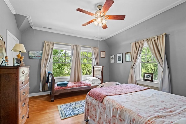 bedroom featuring crown molding, ceiling fan, light hardwood / wood-style floors, and vaulted ceiling