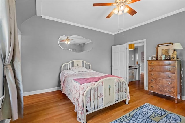 bedroom with hardwood / wood-style flooring, crown molding, vaulted ceiling, and ceiling fan