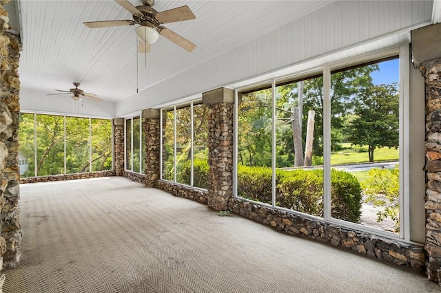 unfurnished sunroom with ceiling fan