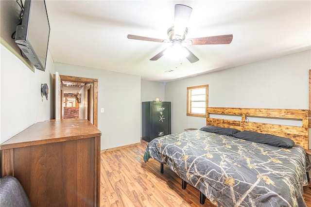 bedroom with light hardwood / wood-style flooring and ceiling fan