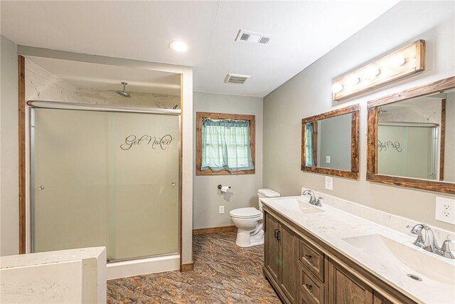 bathroom with double vanity, walk in shower, toilet, and tile patterned floors