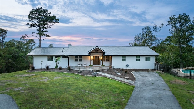 ranch-style house with a lawn