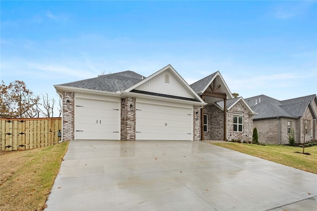 view of front of property featuring a front lawn and a garage