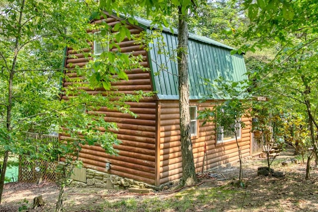 view of side of home with log veneer siding