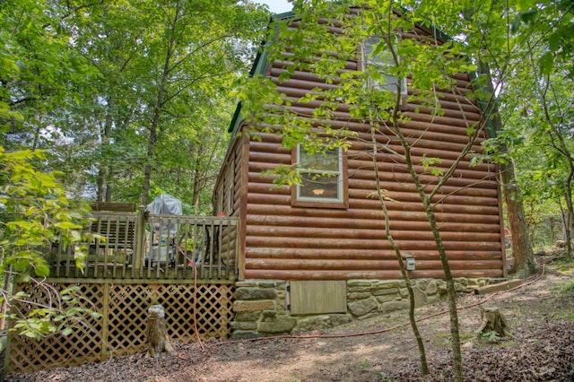 view of side of property featuring a wooden deck