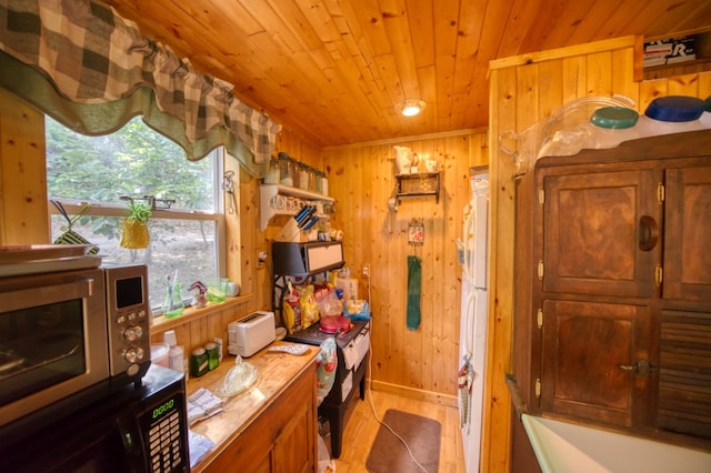 bathroom featuring wood walls and wooden ceiling