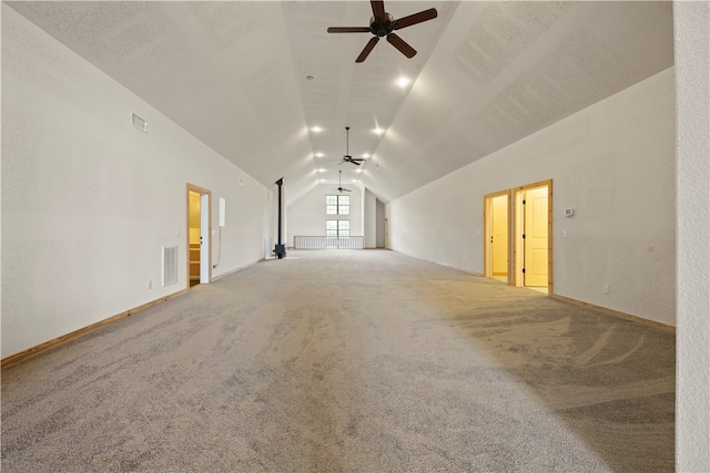 interior space with ceiling fan, light carpet, and vaulted ceiling