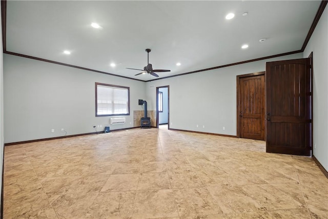 unfurnished room with baseboards, a ceiling fan, ornamental molding, and a wood stove