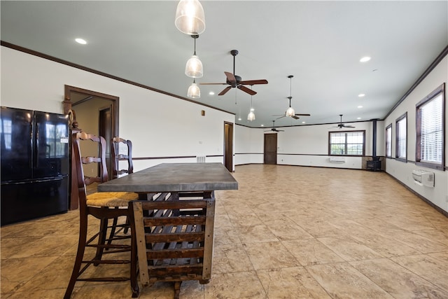 interior space featuring ornamental molding, ceiling fan, and black fridge