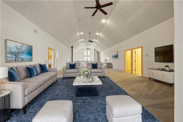 living room with visible vents, a ceiling fan, carpet flooring, and vaulted ceiling