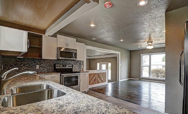 kitchen with white cabinetry, sink, light hardwood / wood-style flooring, and appliances with stainless steel finishes