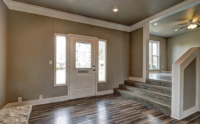 foyer entrance with dark wood-type flooring and a textured ceiling