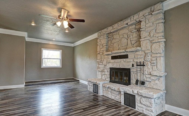 unfurnished living room with crown molding, dark wood-type flooring, a fireplace, and a textured ceiling