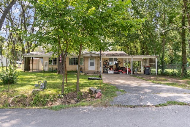 single story home featuring a carport and a front lawn