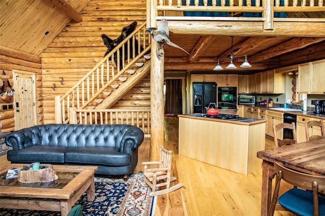 kitchen featuring rustic walls, wooden ceiling, light hardwood / wood-style floors, and black appliances