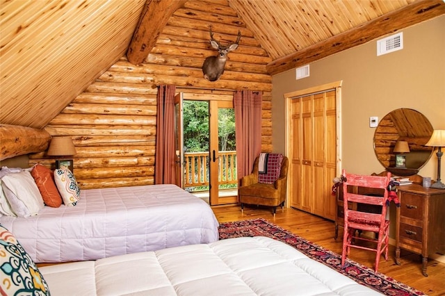 bedroom with lofted ceiling, rustic walls, access to exterior, light hardwood / wood-style floors, and a closet